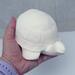 Paintable ceramic turtle statue in my hand for size comparison.
